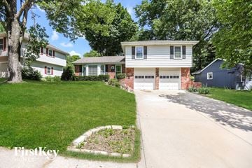 Overland Park house for rent - a white house with a driveway and a garage door