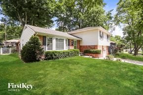 Overland Park house for rent - a small white house with a lawn and trees