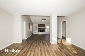 Indianapolis house for rent - A spacious room with wooden floors and white walls.