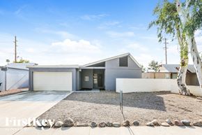 Phoenix house for rent - A modern house with a gravel driveway and a birch tree in front.