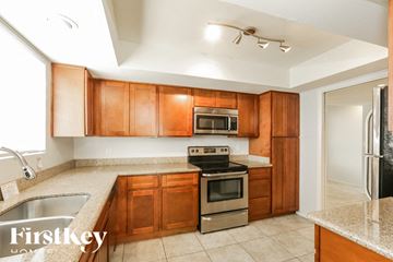 Phoenix house for rent - A kitchen with wooden cabinets and a stainless steel oven.