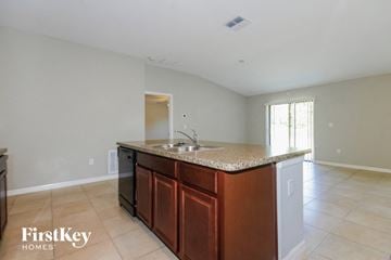 Ruskin house for rent - A kitchen with a brown counter top and a sink.