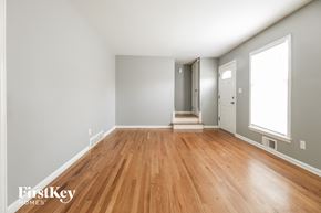 Overland Park house for rent - a living room with wood flooring and a door to a hallway