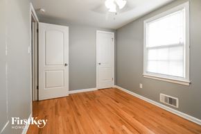 Overland Park house for rent - a bedroom with wood floors and a white door and a window