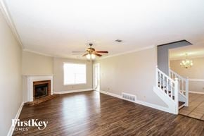 Lakeland house for rent - A spacious room with a fireplace and a staircase.