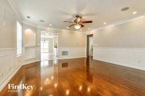 Avon house for rent - A spacious room with wooden floors and a ceiling fan.