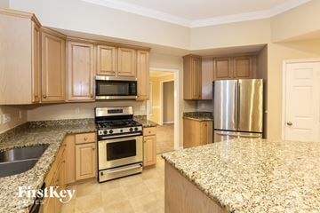 Charlotte house for rent - A kitchen with granite countertops and stainless steel appliances.