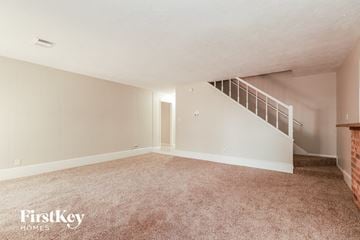 Spring house for rent - a living room with carpet and a staircase