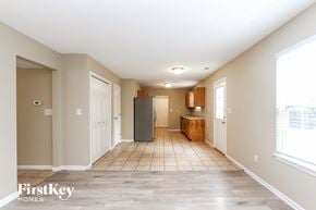 Avon house for rent - A spacious, empty room with a refrigerator in the middle.