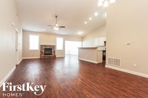 Avon house for rent - A spacious living room with wood flooring and a fireplace.