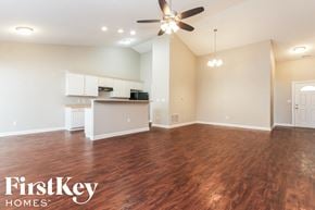 Avon house for rent - A spacious room with wooden floors and a ceiling fan.