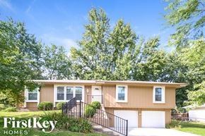 Kansas City house for rent - front view of a home with trees and a driveway