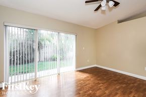 Cutler Bay house for rent - an empty living room with a sliding glass door to the yard
