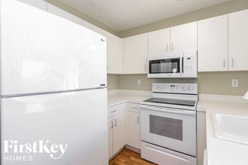 Cutler Bay house for rent - a white kitchen with white appliances and white cabinets