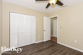 Cutler Bay house for rent - a bedroom with a ceiling fan and a door to a closet