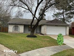 Conroe house for rent - a white brick house with a tree in the yard