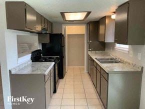 Conroe house for rent - a kitchen with stainless steel appliances and counter tops