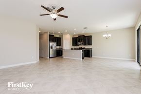 Ruskin house for rent - an empty kitchen and living room with a ceiling fan