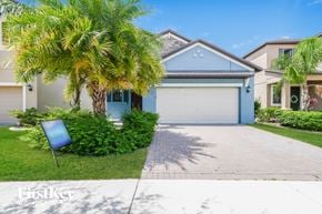 Ruskin house for rent - A house with a blue garage door is for sale.
