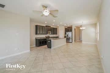Ruskin house for rent - A spacious kitchen with a fan and a bar area.