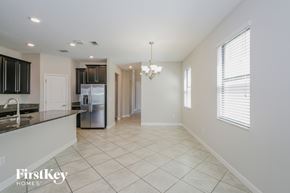 Ruskin house for rent - A spacious kitchen with a tile floor and a chandelier hanging from the ceiling.