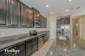 Ruskin house for rent - A kitchen with granite countertops and stainless steel appliances.