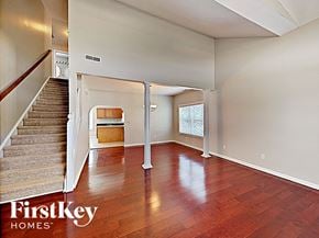Indianapolis house for rent - an empty living room with wood floors and a staircase