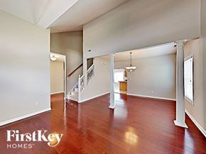 Indianapolis house for rent - an empty living room with wood floors and a staircase