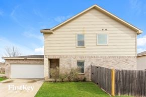 Dallas house for rent - a brick house with a wooden fence and a lawn