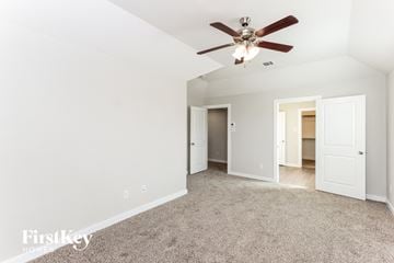 Dallas house for rent - a living room with carpet and a ceiling fan