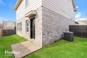Dallas house for rent - the outside of a house with a walkway and grass