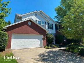 Loveland house for rent - A house with a red brick facade and a white garage door.