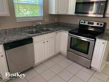 Loveland house for rent - A kitchen with a stove top oven and a sink.