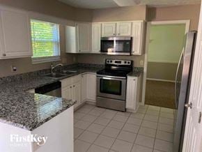 Loveland house for rent - A kitchen with granite countertops and stainless steel appliances.