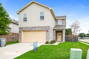 Dallas house for rent - A house with a garage and a sign that says "FirstKey Home".