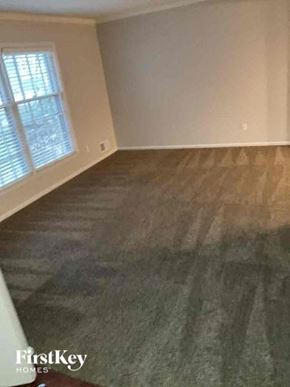 Overland Park house for rent - an empty living room with wood floors and a window