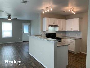 Dallas house for rent - an empty kitchen with white cabinets and a counter top