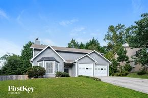Canton house for rent - A house with a grey roof and a white garage door is shown.