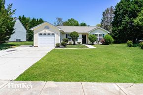Concord house for rent - a white house with a lawn and a white garage door