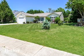 Concord house for rent - a home with a lawn and a small tree in front of it
