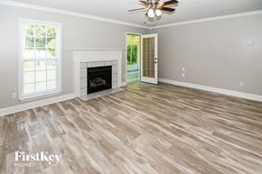 Concord house for rent - the living room of a home with a fireplace and wooden floors