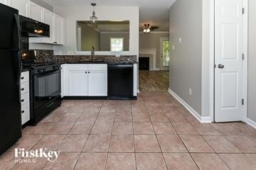 Concord house for rent - a kitchen with black appliances and white cabinets