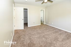 Concord house for rent - a bedroom with a carpeted floor and a ceiling fan