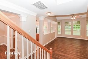 Charlotte house for rent - a living room with wood floors and a staircase      and a