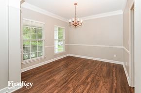 Charlotte house for rent - a dining room with wood floors and a chandelier