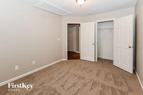 Charlotte house for rent - a bedroom with a carpeted floor and a closet with two doors