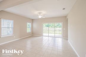 Jacksonville house for rent - A spacious room with a sliding glass door leading to a garden.