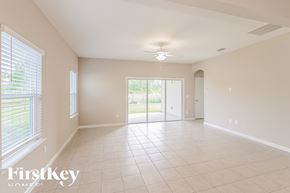 Jacksonville house for rent - A spacious room with a sliding glass door leading to a backyard.