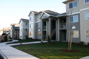Bellingham apartment for rent - a row of houses with a sidewalk and grass