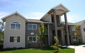 Bellingham apartment for rent - a gray house with a balcony and a yard